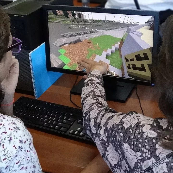 people at computer with Minecraft on screen