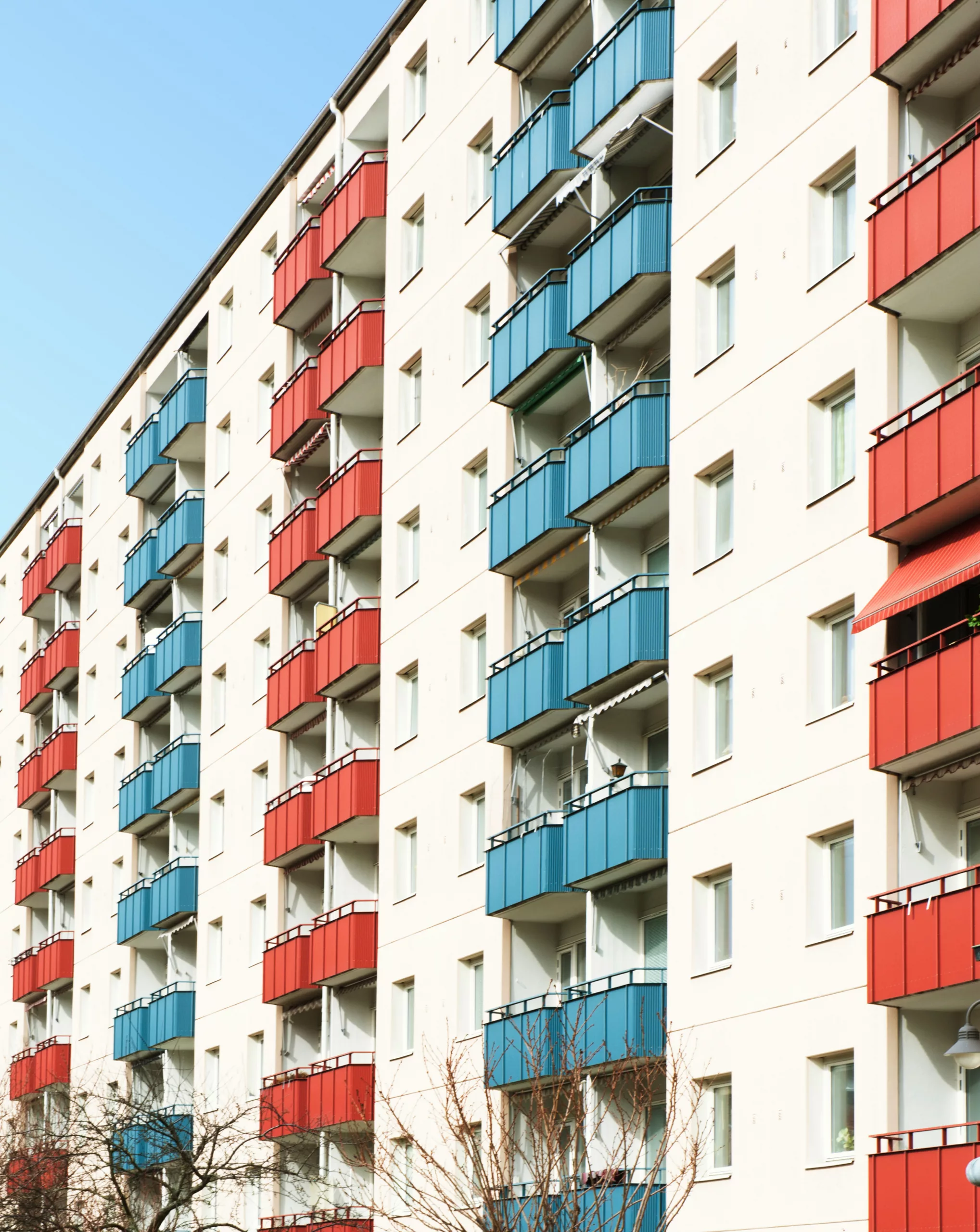 red, while and blue painted housing building in Stockholm