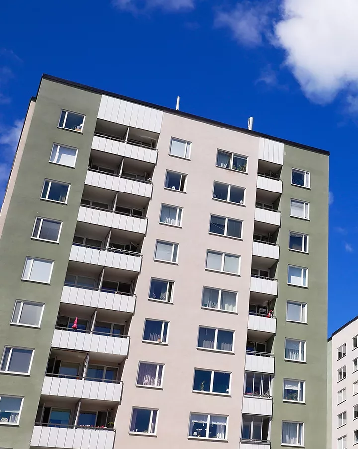 green and grey painted housing building in Stockholm