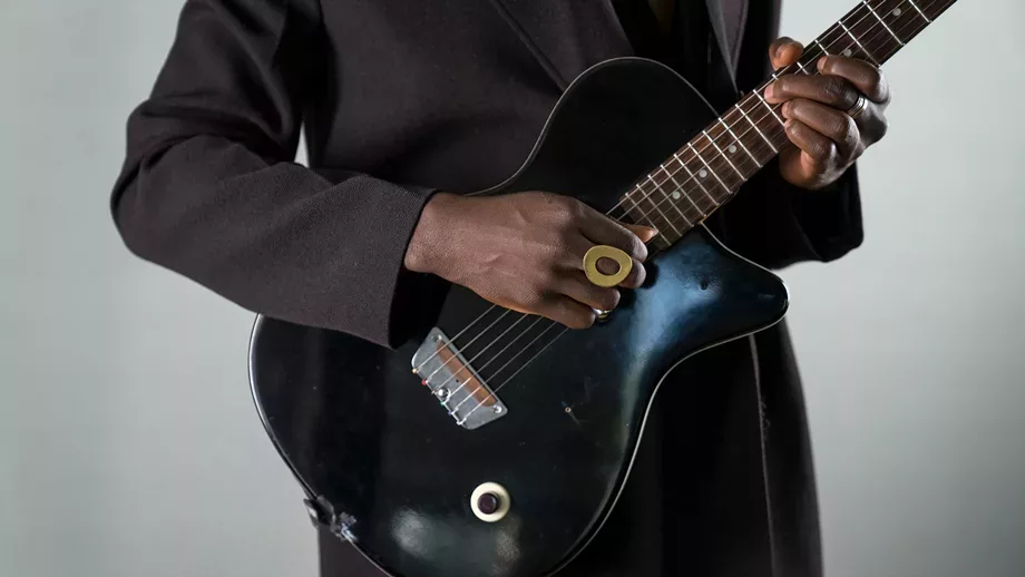 close up of hands on a guitar