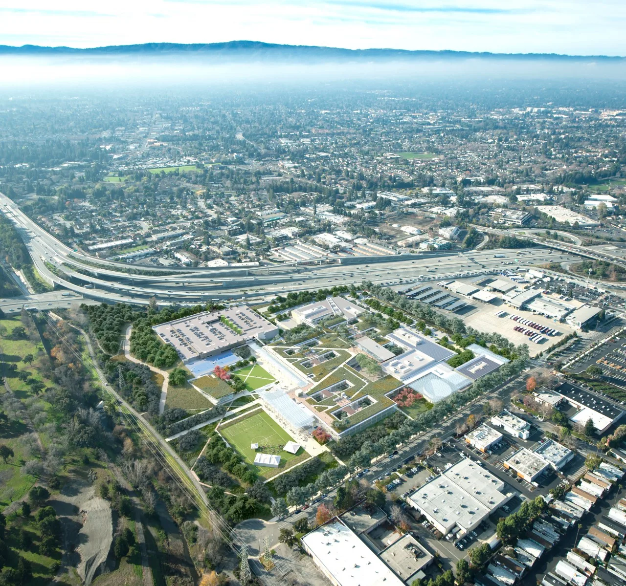 An aerial view of a campus with a large parking lot.