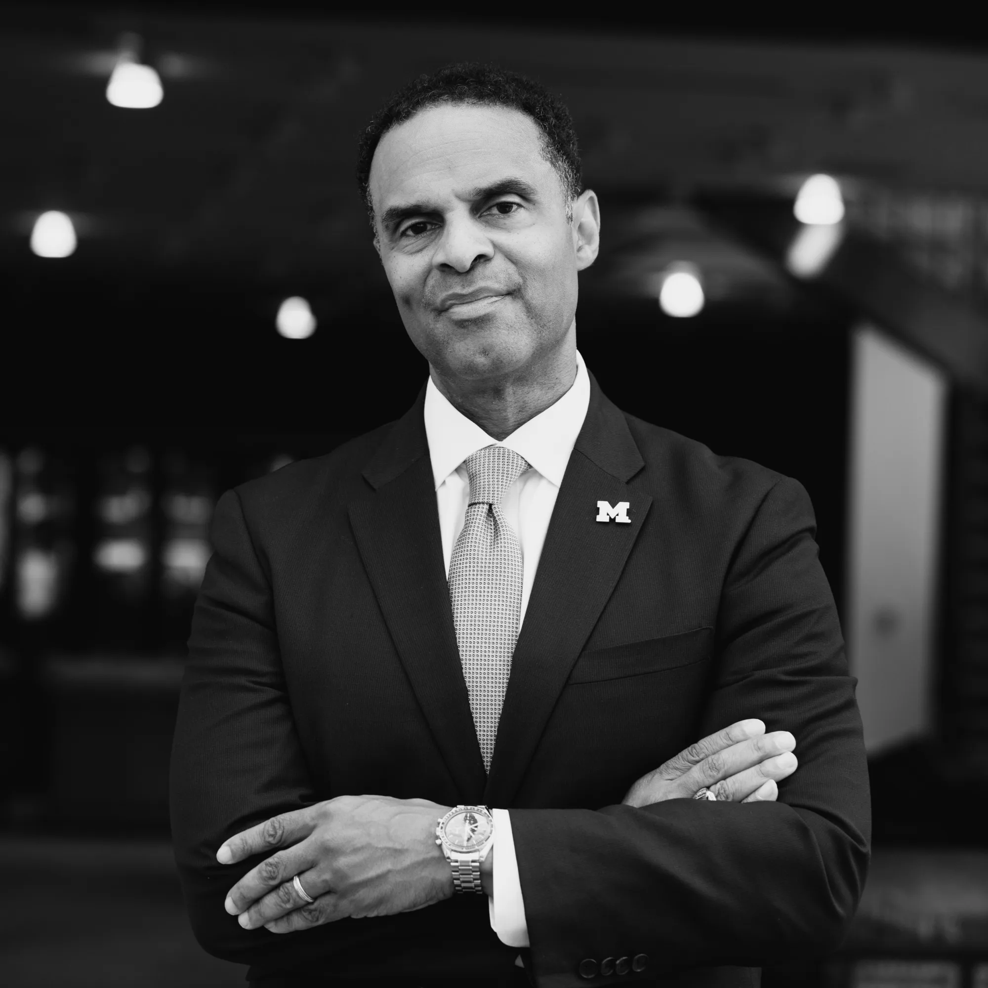 A black and white photo of a man in a suit.